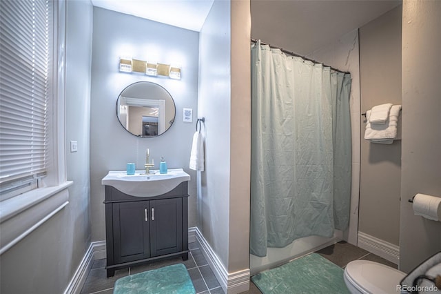 bathroom featuring tile patterned flooring, vanity, and toilet