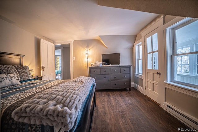 bedroom with a baseboard radiator and dark hardwood / wood-style floors