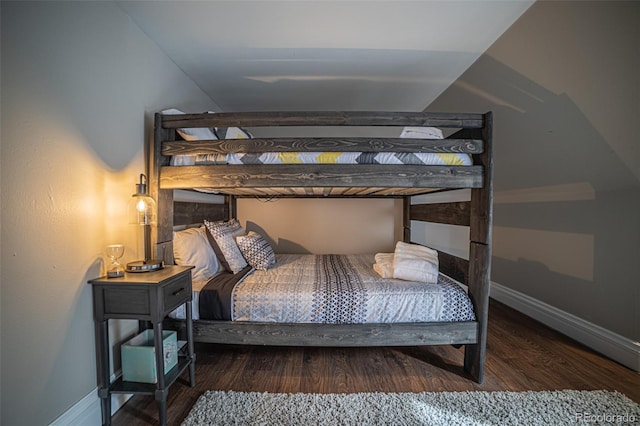 bedroom featuring dark hardwood / wood-style floors and vaulted ceiling