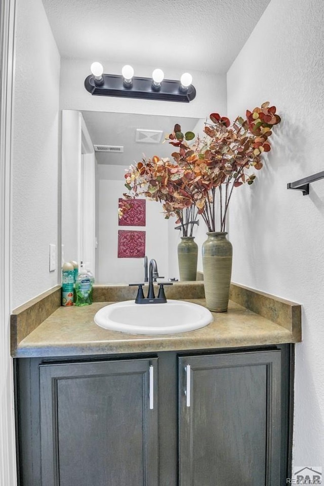 bathroom with vanity and a textured ceiling