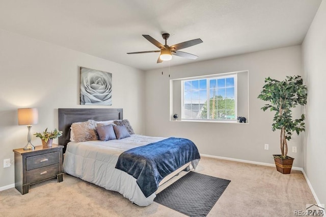 bedroom featuring light colored carpet and ceiling fan