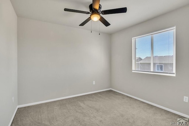 spare room with ceiling fan and light carpet