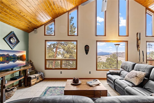 living area with wooden ceiling, a mountain view, baseboards, and light tile patterned floors