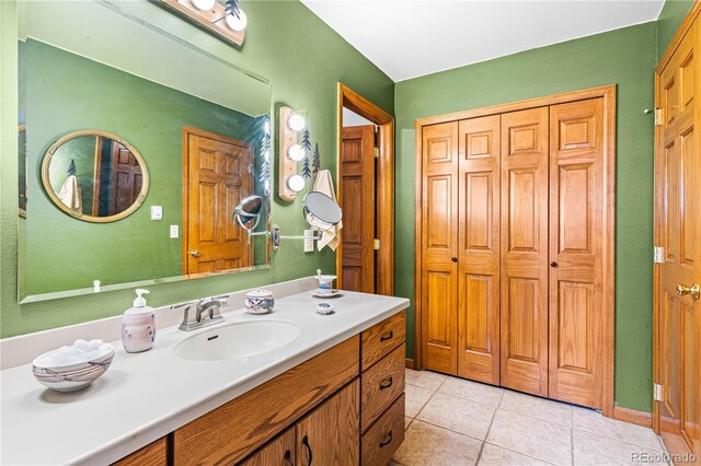 bathroom with tile patterned flooring and vanity