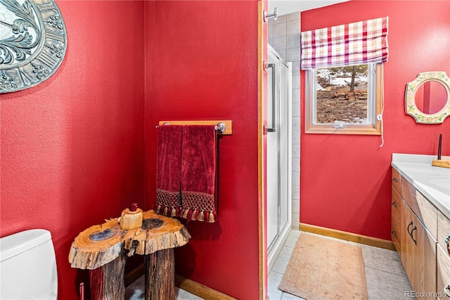 full bath with a stall shower, baseboards, toilet, tile patterned flooring, and vanity