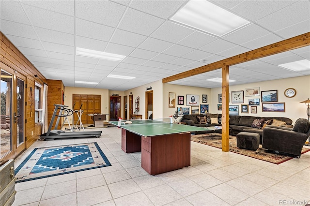 game room featuring a paneled ceiling and light tile patterned floors