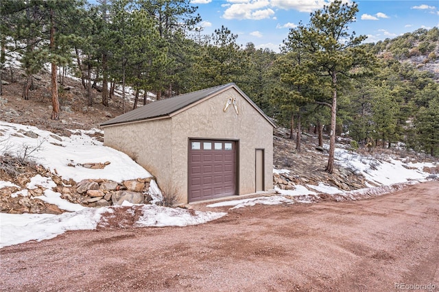 exterior space with driveway and an outdoor structure