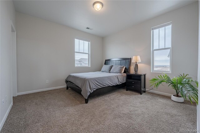 bedroom with carpet and baseboards