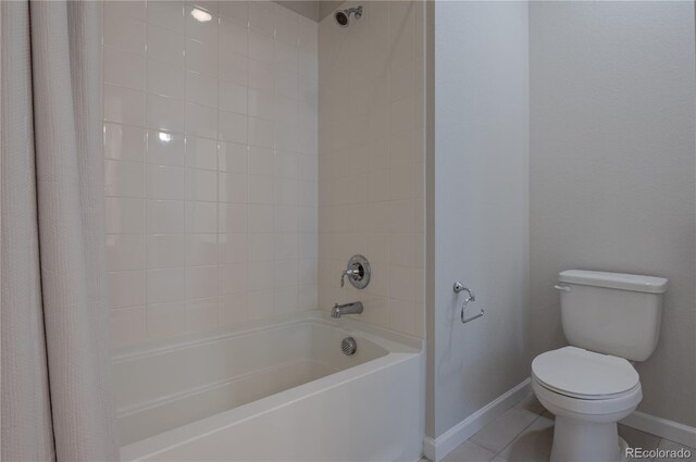 bathroom featuring toilet, baseboards, shower / bathtub combination with curtain, and tile patterned flooring