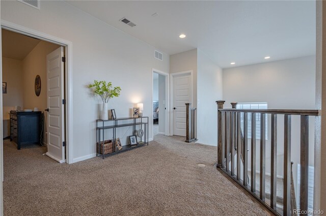 hallway with recessed lighting, visible vents, and carpet floors