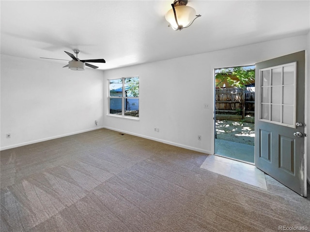 carpeted spare room featuring ceiling fan