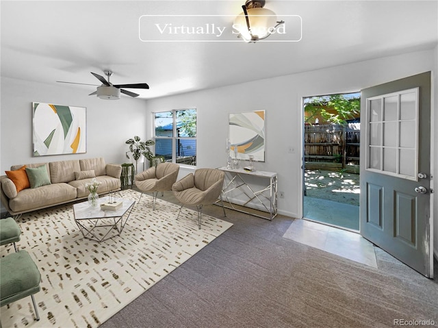 carpeted living room featuring ceiling fan