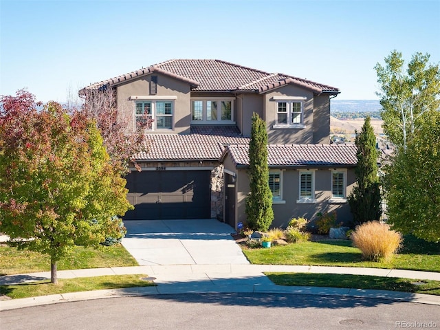 mediterranean / spanish house with a garage