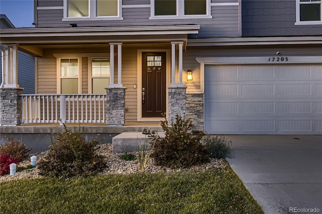 property entrance with a garage and covered porch