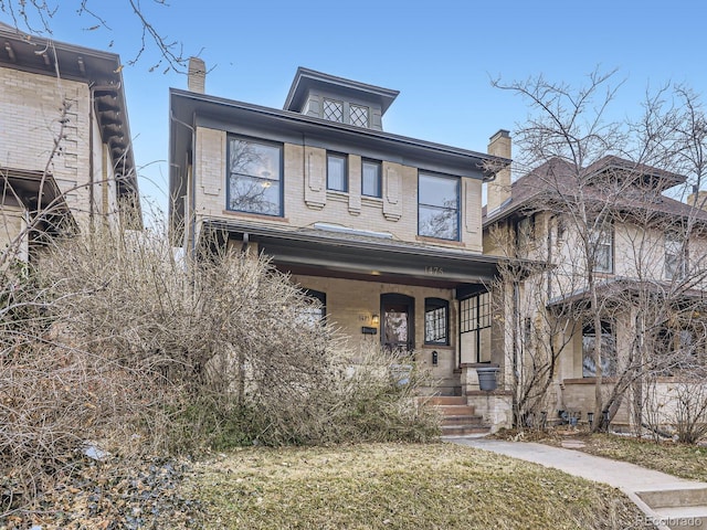 traditional style home with a porch and brick siding