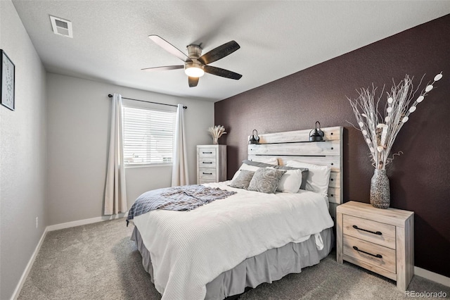 carpeted bedroom featuring a textured ceiling and ceiling fan