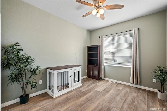 interior space with ceiling fan and light hardwood / wood-style flooring