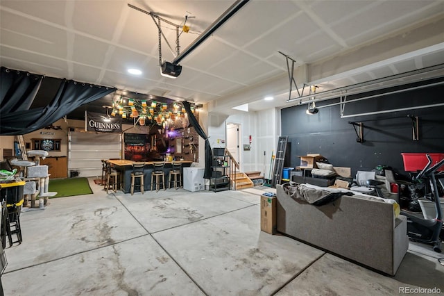 garage featuring a garage door opener and a workshop area