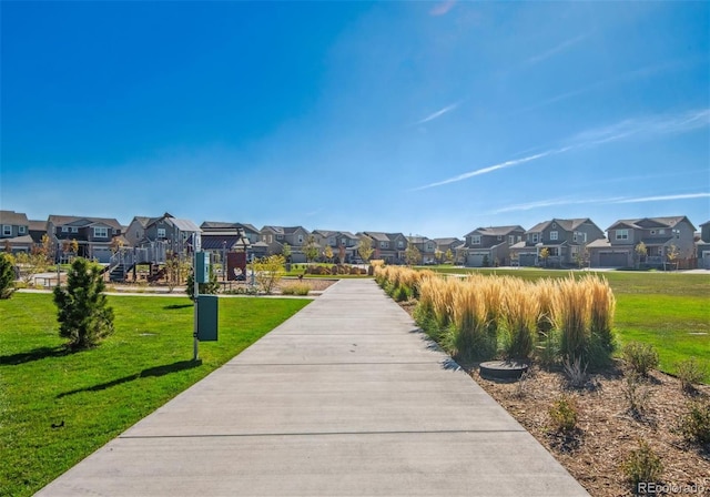 view of home's community with a residential view and a lawn