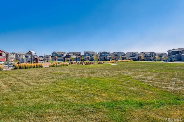 view of green lawn featuring a residential view