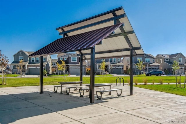 surrounding community with a residential view and a lawn