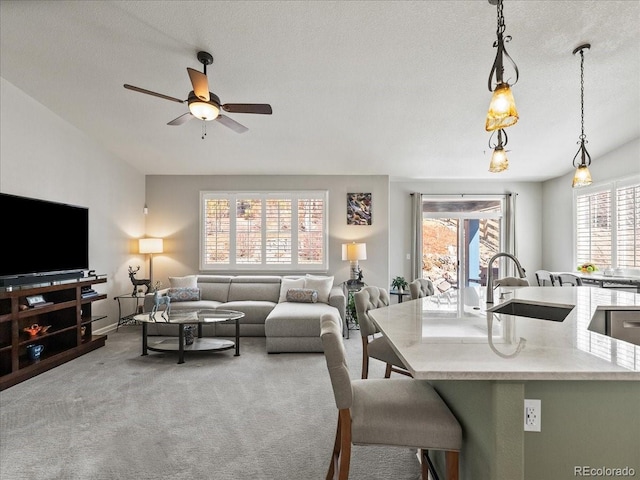 living room with a ceiling fan and carpet flooring