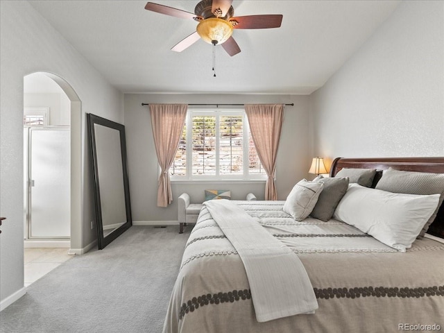 bedroom with arched walkways, carpet flooring, ceiling fan, and baseboards