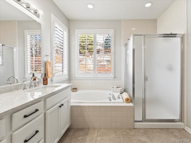 full bath with a bath, a stall shower, vanity, and tile patterned floors