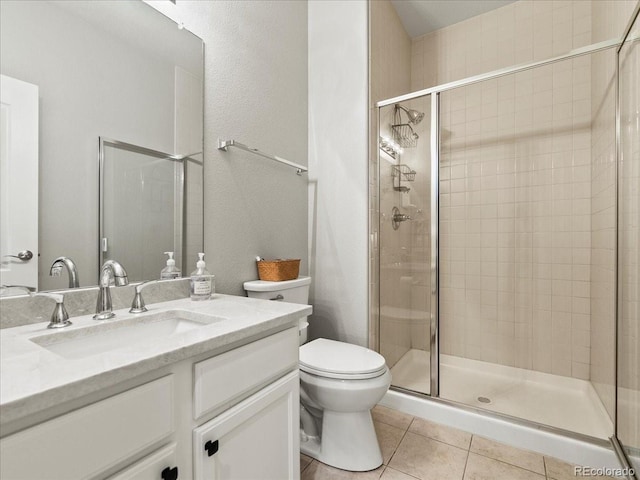 bathroom featuring toilet, tile patterned flooring, vanity, and a shower stall