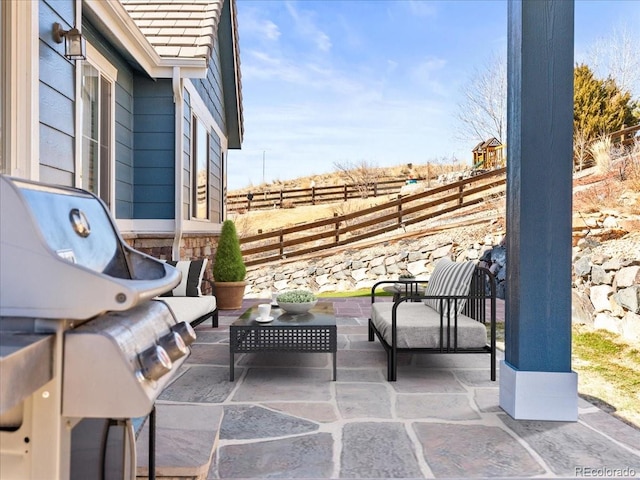 view of patio / terrace with an outdoor hangout area and fence