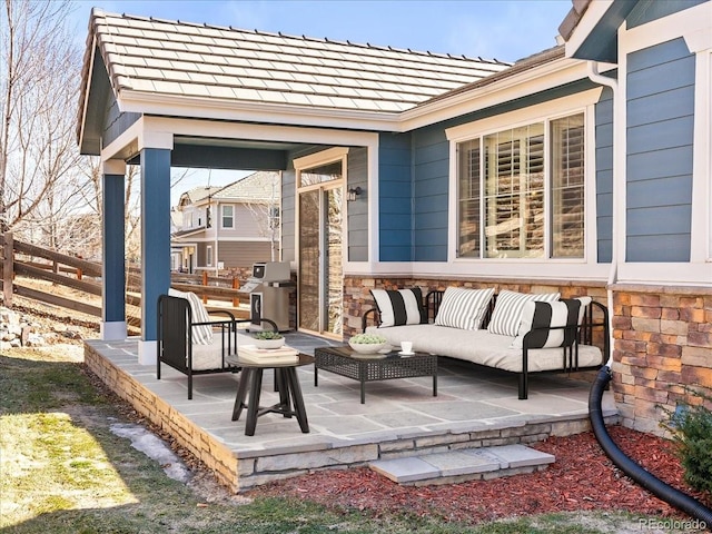 view of patio / terrace with a grill, fence, and outdoor lounge area