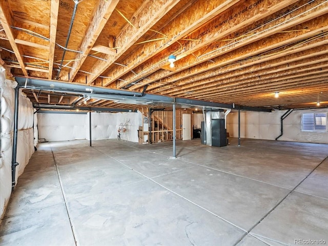 unfinished basement featuring heating unit