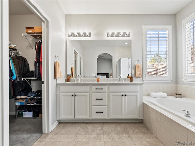 23327 E Ottawa Dr, Aurora, CO 80016 - full bathroom featuring double vanity, a garden tub, a stall shower, and a spacious closet
