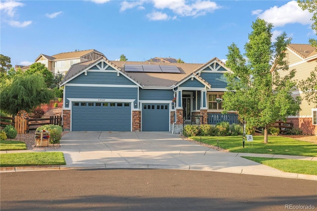 23327 E Ottawa Dr, Aurora, CO 80016 - craftsman house featuring a porch, solar panels, an attached garage, driveway, and stone siding