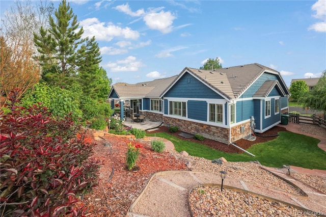 23327 E Ottawa Dr, Aurora, CO 80016 - back of property featuring stone siding, a patio area, and a tiled roof