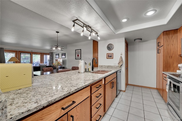 kitchen featuring light stone counters, sink, stainless steel appliances, and a textured ceiling