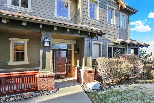 view of exterior entry with covered porch