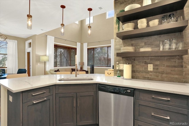 kitchen with open shelves, light stone counters, a sink, a peninsula, and dishwasher