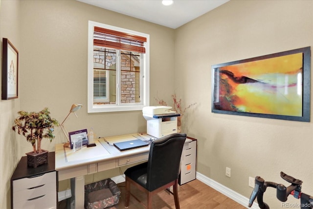 home office featuring baseboards and wood finished floors