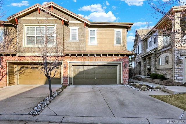 view of front of house with brick siding, concrete driveway, an attached garage, and a tile roof