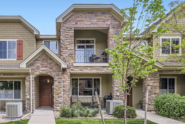 15362 W 66th Ave Unit D, Arvada, CO 80007 - craftsman inspired home with central AC unit, a balcony, and stone siding