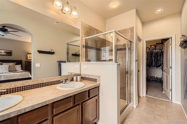 15362 W 66th Ave Unit D, Arvada, CO 80007 - ensuite bathroom with a shower stall, double vanity, a spacious closet, a ceiling fan, and recessed lighting