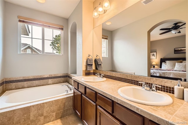 15362 W 66th Ave Unit D, Arvada, CO 80007 - ensuite bathroom with a garden tub, double vanity, a ceiling fan, and tile patterned floors