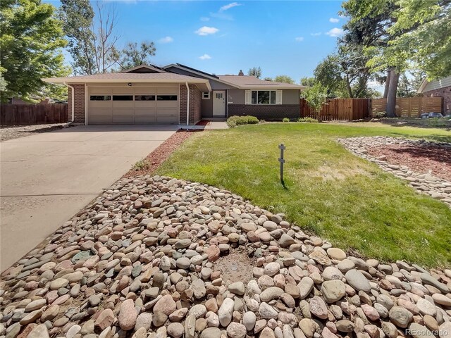 ranch-style house with a garage and a front yard