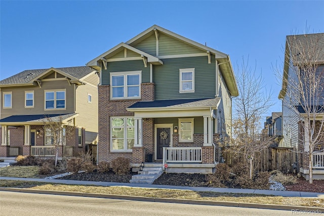 craftsman-style home featuring a porch and brick siding