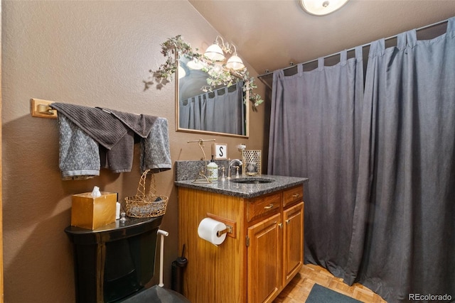 11485 Pecos St, Denver, CO 80234 - bathroom with vanity, a shower with shower curtain, and lofted ceiling