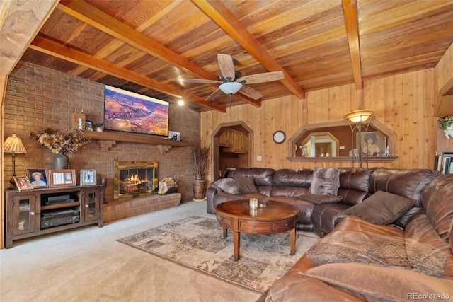 11485 Pecos St, Denver, CO 80234 - carpeted living room with a wooden ceiling with exposed beams, ceiling fan, a brick fireplace, wooden walls, and arched walkways