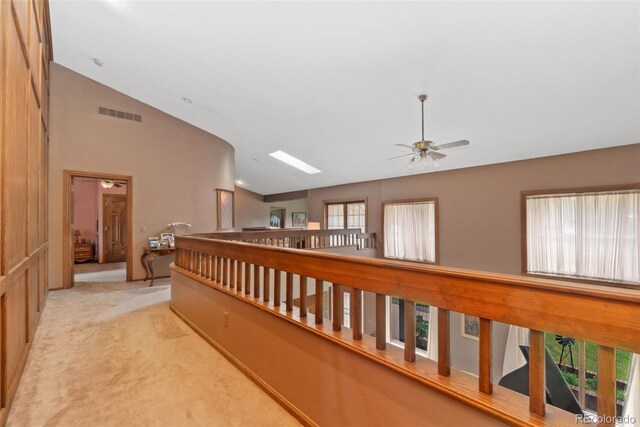 11485 Pecos St, Denver, CO 80234 - corridor featuring light colored carpet, high vaulted ceiling, and an upstairs landing