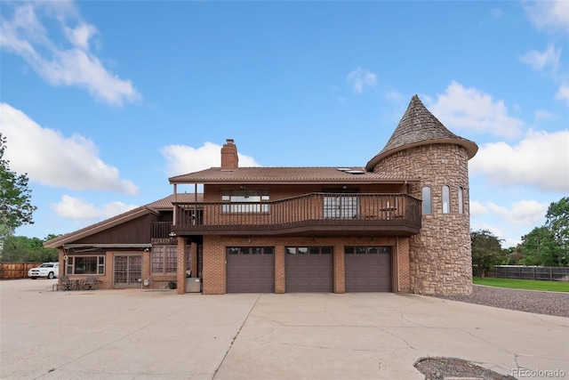 11485 Pecos St, Denver, CO 80234 - view of front of property with a balcony, a chimney, a garage, and concrete driveway