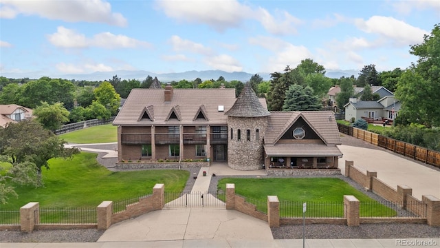 11485 Pecos St, Denver, CO 80234 - view of front facade featuring a gate, a fenced front yard, a balcony, and a chimney